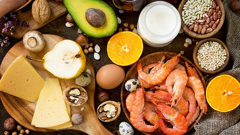 Protein items, fruits, juice and vegetables on a rustic wooden background. 