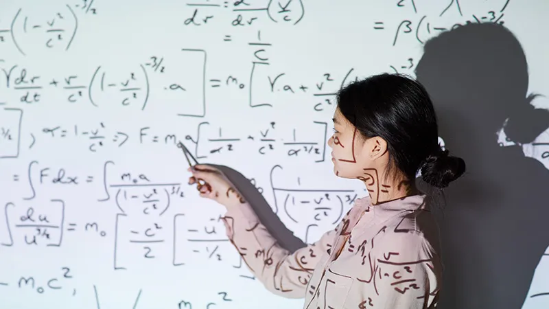 A female teacher teaching further maths 