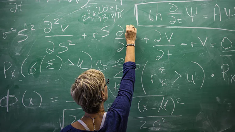 A female teacher teaching maths in school 