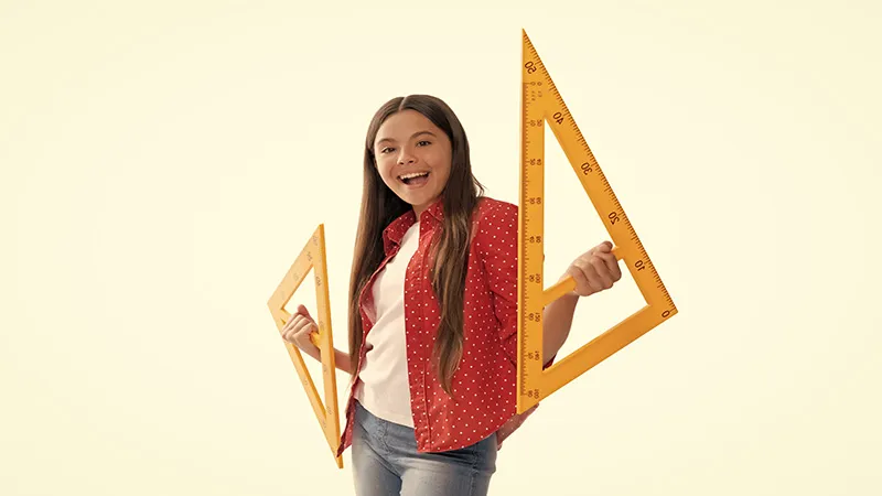 Smiling funny teen girl hold triangle ruler