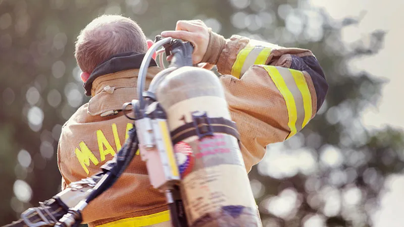 Firefighters carries a fire extinguisher for work 