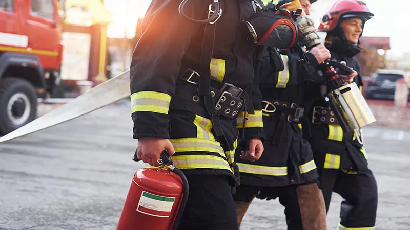 Group of firefighters in protective uniform at fire stations