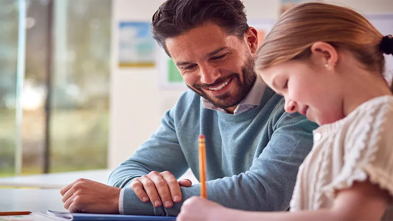 A female students in school classroom with a teacher