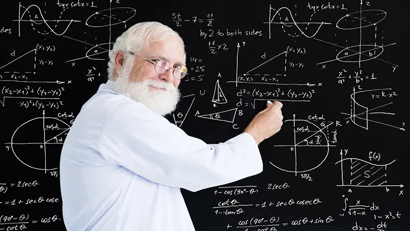 A male math teacher shows maths on the blackboard