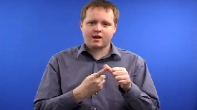 Bsl interpreter touching his left hand thumb with index finger of right hand