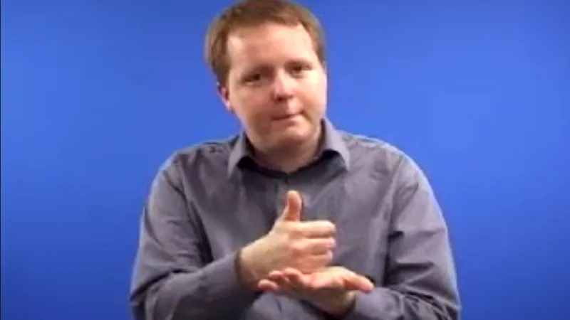 BSL interpreter with thumbs-up gesture