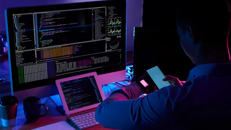 A programmer coding in his workspace