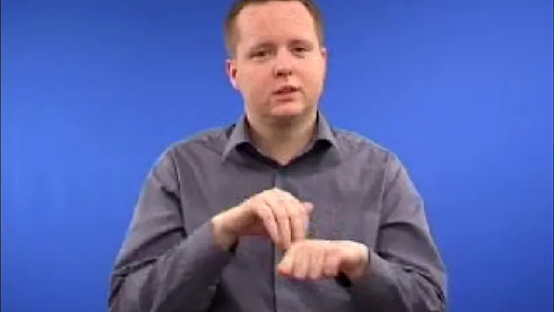 BSl interpreter showing hand gesture of Christmas
