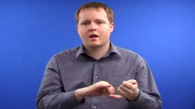 Male instructor using both hands to sign in British Sign Language