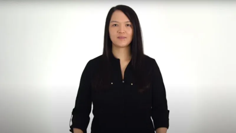 BSL tutor standing in black dress