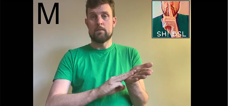 A Man Demonstrating How to Sign the Letter M