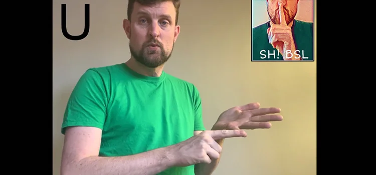 A Man Demonstrating How to Sign the Letter U
