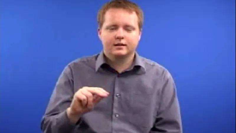 BSL interpreter showing hand gesture 