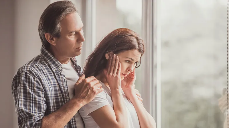 Husband comforting upset wife and tries to understand her