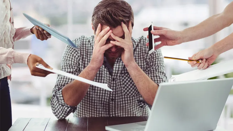 Stressed employee with his hands on his head