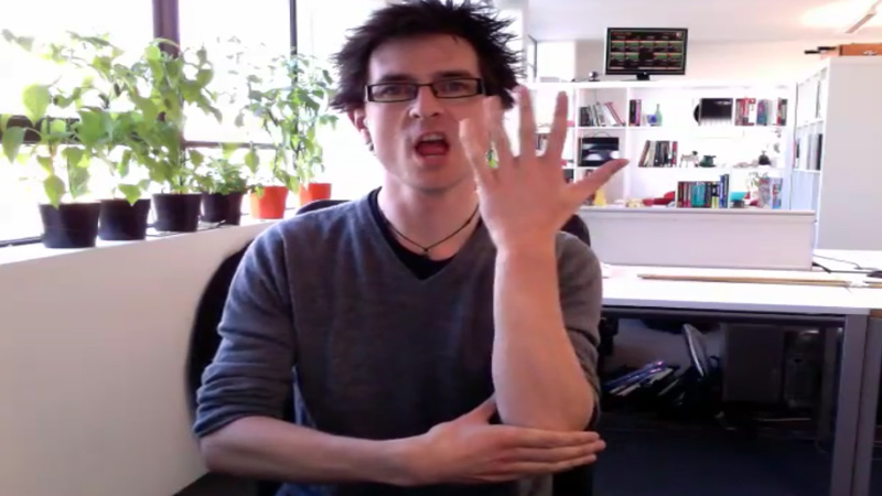 A man shows how to sign “Tree” in British Sign Language with hand posture