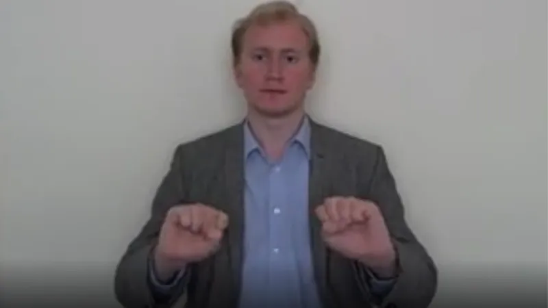 British Sign Language interpreter signing Wait