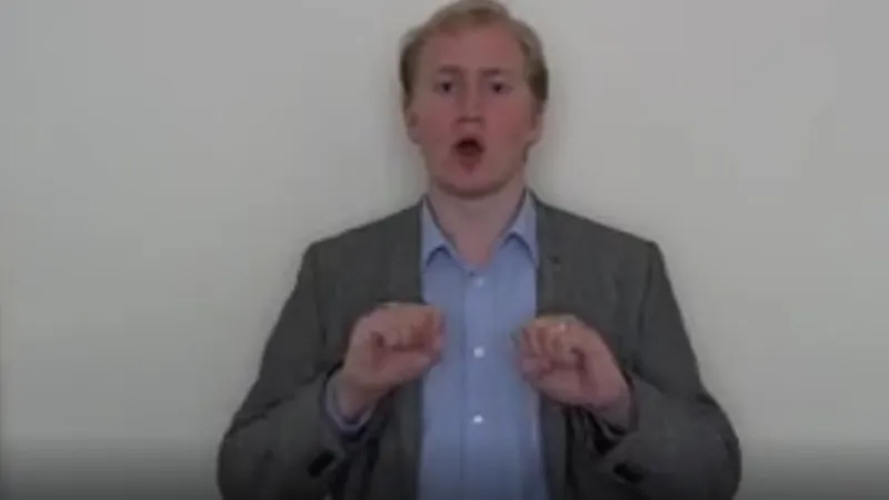 British Sign Language interpreter with both the hands raised