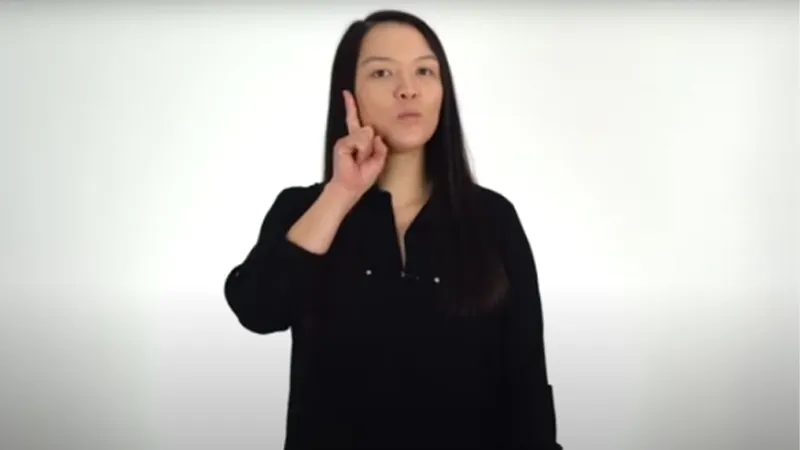 BSL tutor showing index finger of her right hand