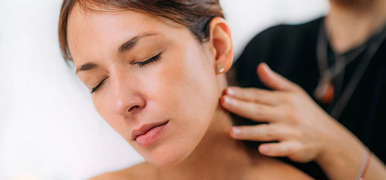 A woman taking head and neck massage