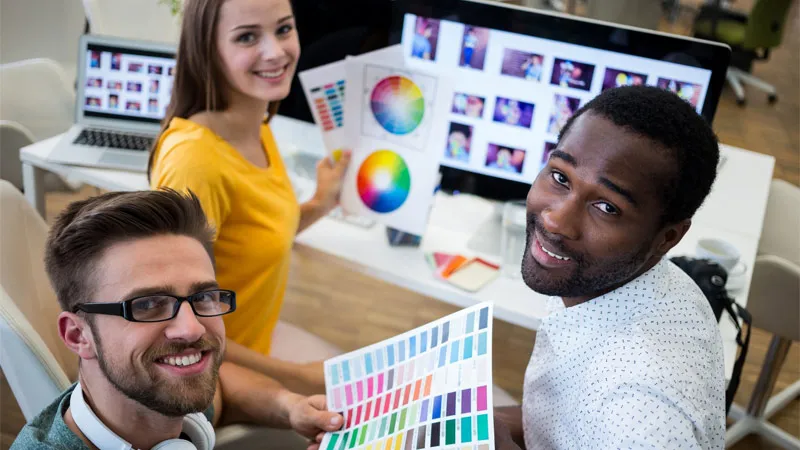 Graphic designers holding colour cards