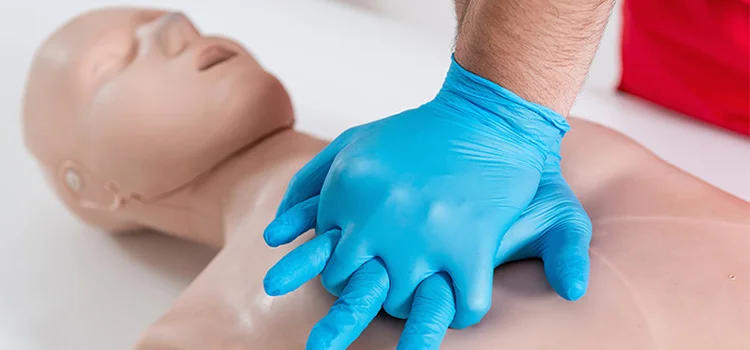 A first aider demonstrating CPR