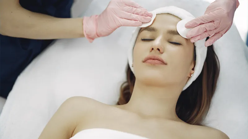 A dermatologist treating her female patient