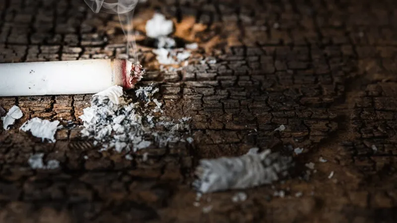 A burning cigarette on the floor
