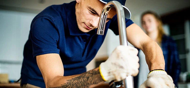 A plumber fixing kitchen sink