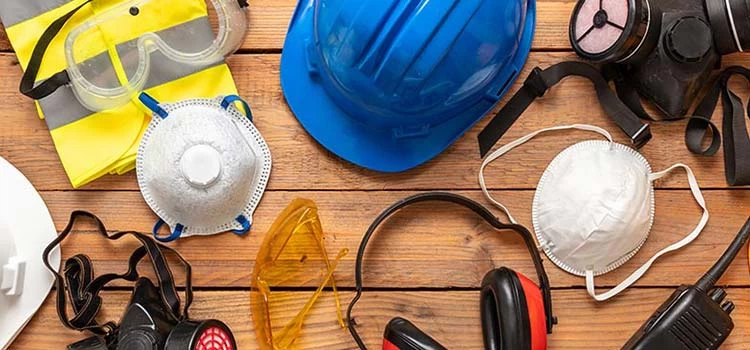 Helmet, gloves, air mask, smoke mask, safety glasses and other safety gears kept on a wooden floor