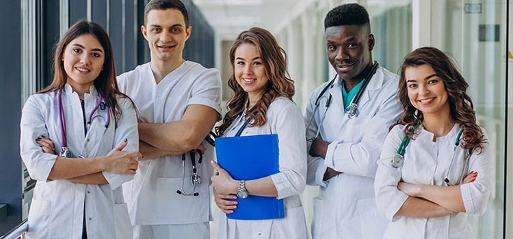 Team of young specialist doctors standing in the corridor of the hospital.