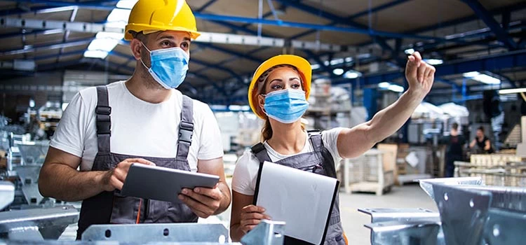 Two healthy and safety officers at work in a manufacturing unit