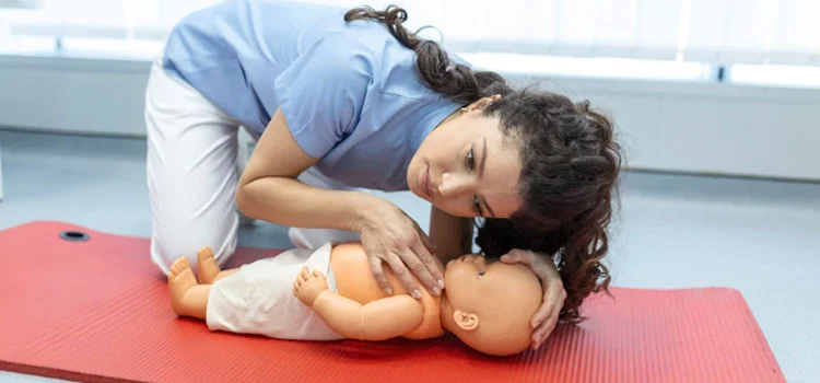 Woman performing CPR on Baby Doll With One Hand Compression First Aid Training