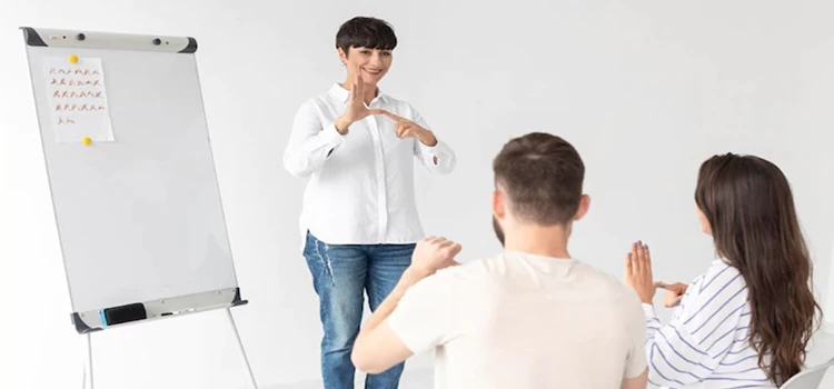 A british sign language instructor teaching students how to sign
