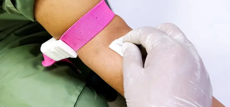 A Phlebotomist Disinfects Blood Collection Area by Alcohol Pad in Hospital