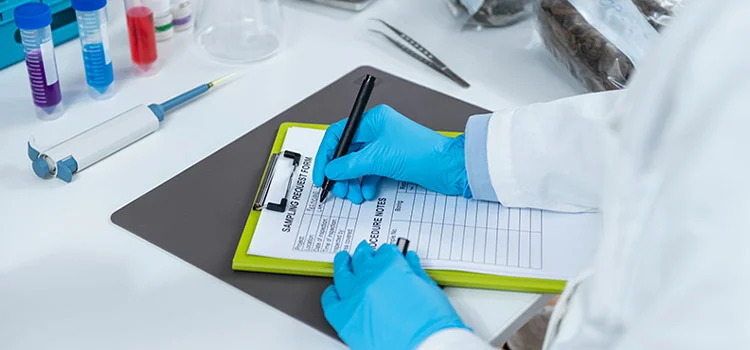 A Phlebotomist Filling Sample Request Form for a Laboratory