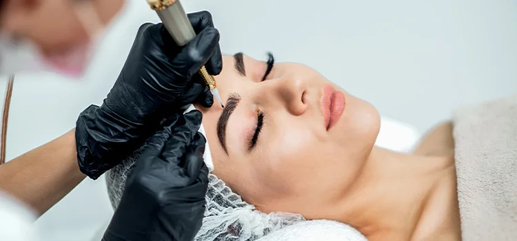 A Permanent Makeup Artist performing permanent eyebrow procedure