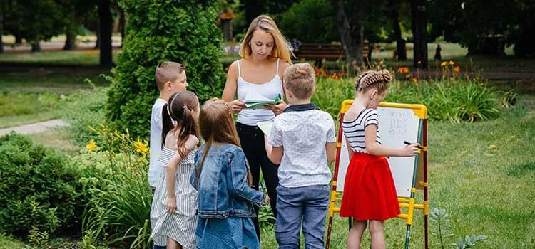 A Teacher Teaches a Class of Children in an Outdoor Park
