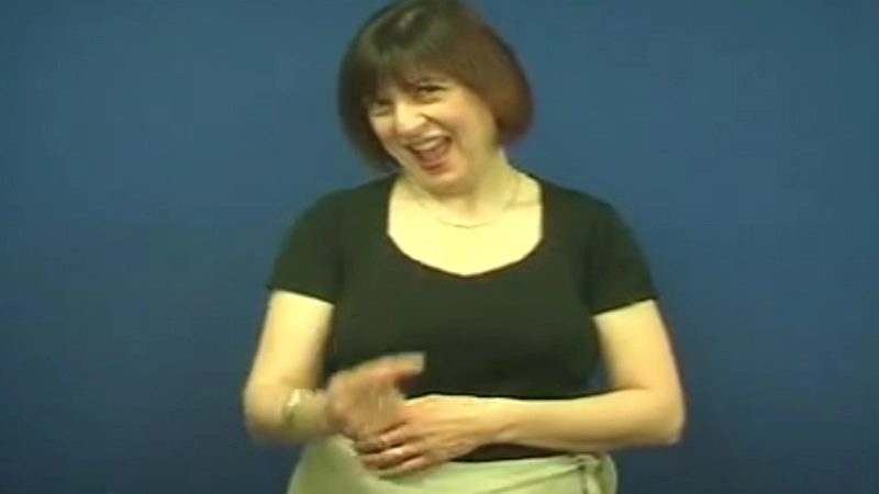 Woman shows how to sign “Can” in British Sign Language with hand posture