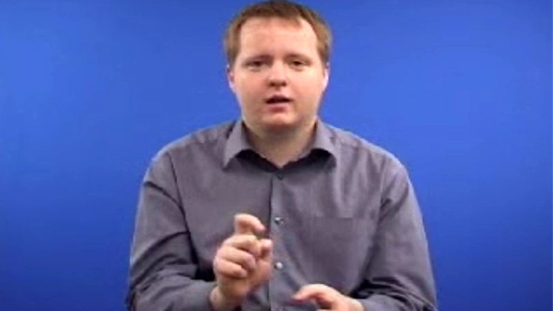 A man shows how to sign “Can” in British Sign Language with hand posture