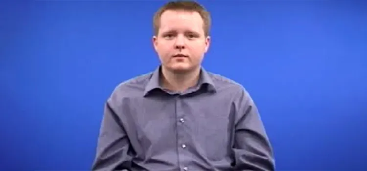 A British Sign Language tutor in a normal posture