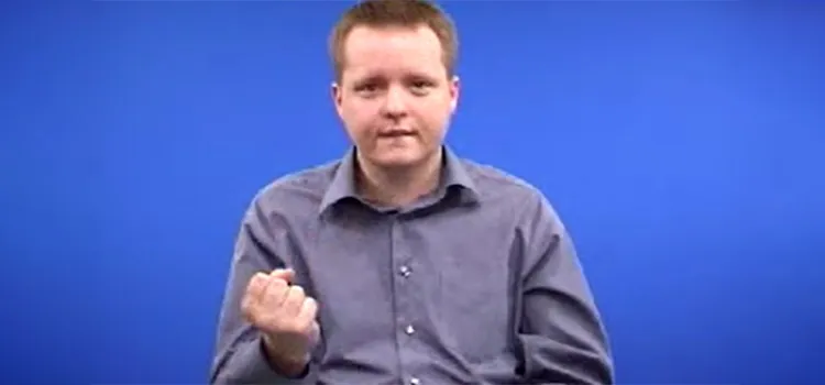 A man shows how to sign “have” in British Sign Language with hand posture