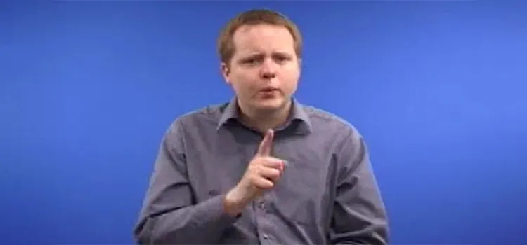 A man shows how to sign “who” in British Sign Language