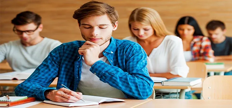  A male student focused on his paper during exam