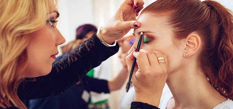 Makeup Artist applying makeup on a client
