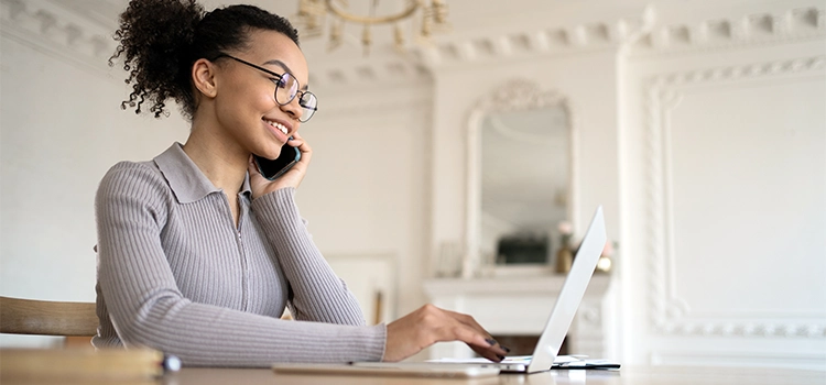 Female freelancer using laptop for preparing finance report at home