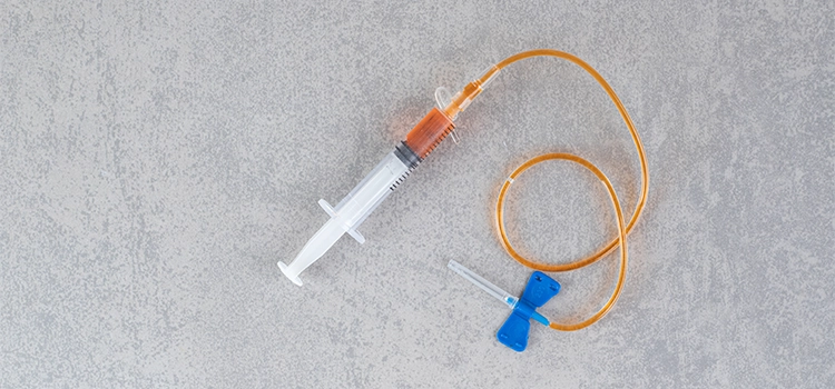  A small syringe with a catheter and insertion needle, containing some medicine. 