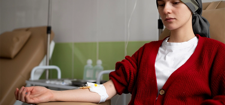 A patient is taking medication with the help of peripheral cannulation in a clinic. 