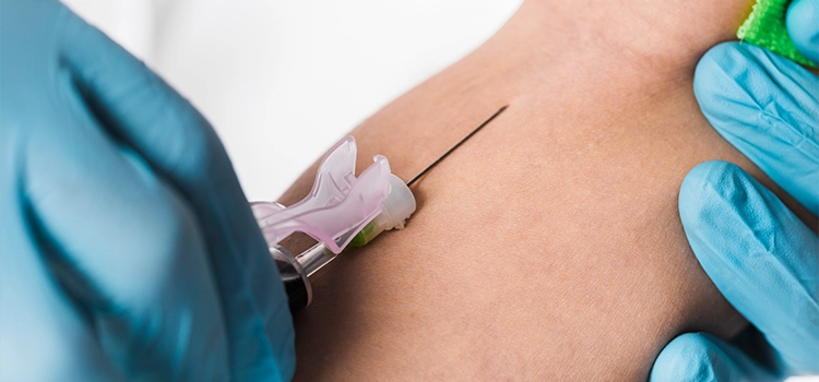 A doctor insertion a cannula into the forearm vein of a patient. 